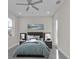 Staged bedroom boasts gray furniture, neutral walls, and a ceiling fan at 4255 Oak Terrace Cir, Port Charlotte, FL 33953
