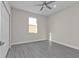 This bedroom offers gray floors, natural light from a window, and a closet at 4255 Oak Terrace Cir, Port Charlotte, FL 33953