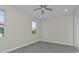 This bedroom offers gray floors, natural light from windows and a ceiling fan at 4255 Oak Terrace Cir, Port Charlotte, FL 33953