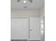 Bedroom closet and door with ceiling fan and gray wood-look flooring at 4255 Oak Terrace Cir, Port Charlotte, FL 33953