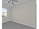 Bright bedroom featuring a ceiling fan, a window, and gray wood-look flooring at 4255 Oak Terrace Cir, Port Charlotte, FL 33953