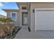 Front exterior of home featuring a two car garage, modern finishes and small decorative landscaping at 4255 Oak Terrace Cir, Port Charlotte, FL 33953