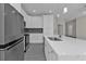 Modern kitchen with stainless steel appliances, gray backsplash, white cabinets, and quartz countertops at 4255 Oak Terrace Cir, Port Charlotte, FL 33953