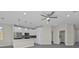 Bright kitchen features white cabinets, stainless appliances, and a ceiling fan at 4255 Oak Terrace Cir, Port Charlotte, FL 33953
