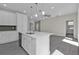 Kitchen featuring an island with sink, white cabinets, and stainless steel dishwasher at 4255 Oak Terrace Cir, Port Charlotte, FL 33953
