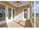 Enclosed porch with ceiling fan, exterior views, and access to both the yard and interior at 4255 Oak Terrace Cir, Port Charlotte, FL 33953