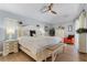 Bright main bedroom with an elegant white bed frame, ceiling fan, and lots of natural light at 7417 S Blue Sage, Punta Gorda, FL 33955