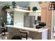Open kitchen with breakfast bar, stainless steel fridge, and ample storage space in neutral tones at 7417 S Blue Sage, Punta Gorda, FL 33955