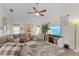 Spacious living room with vaulted ceilings, a comfortable sectional, and a large-screen TV for entertainment at 7417 S Blue Sage, Punta Gorda, FL 33955