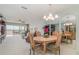 Elegant dining room with a round table and chairs, overlooking the living room at 9011 Midnight Pass Rd # 329, Sarasota, FL 34242