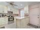 Updated kitchen with light cabinets and breakfast bar at 9011 Midnight Pass Rd # 329, Sarasota, FL 34242