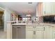 Kitchen with light-colored cabinets, granite countertops, and stainless steel appliances at 9011 Midnight Pass Rd # 329, Sarasota, FL 34242