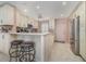 Kitchen with off-white cabinets, stainless steel appliances, and an island at 9011 Midnight Pass Rd # 329, Sarasota, FL 34242