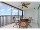 Spacious balcony with glass-top table and chairs, offering scenic water views at 9011 Midnight Pass Rd # 329, Sarasota, FL 34242