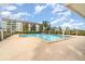Community swimming pool with a surrounding brick patio at 9011 Midnight Pass Rd # 329, Sarasota, FL 34242