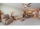 Spacious living room features comfortable seating and a view into the kitchen and dining area at 9011 Midnight Pass Rd # 329, Sarasota, FL 34242