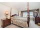 Main bedroom with a four poster bed and ensuite bathroom at 9011 Midnight Pass Rd # 329, Sarasota, FL 34242