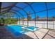 Inviting screened pool and spa area with brick pavers at 14294 Mcfarland Ave, Port Charlotte, FL 33981