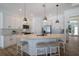 Modern kitchen with white cabinets, large island, and stainless steel appliances at 14294 Mcfarland Ave, Port Charlotte, FL 33981