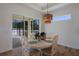 Bright dining room with white table and chairs, offering pool views at 14294 Mcfarland Ave, Port Charlotte, FL 33981