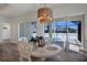 Bright dining room with white table and chairs, offering pool views at 14294 Mcfarland Ave, Port Charlotte, FL 33981