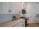 White kitchen with stainless steel appliances and decorative backsplash at 14294 Mcfarland Ave, Port Charlotte, FL 33981