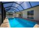 Relaxing screened pool and spa with covered patio access at 14294 Mcfarland Ave, Port Charlotte, FL 33981