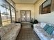 Relaxing screened porch with comfortable seating at 707 Riverview Cir, North Port, FL 34287