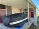 Covered carport with space for one car and extra storage at 707 Riverview Cir, North Port, FL 34287