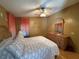 Spacious bedroom with dresser and ceiling fan at 707 Riverview Cir, North Port, FL 34287