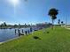 Relaxing canalfront view with grassy area and benches at 707 Riverview Cir, North Port, FL 34287