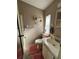 Bathroom with toilet, sink, and shower at 707 Riverview Cir, North Port, FL 34287