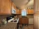Kitchen with wood cabinets, granite countertops, and modern appliances at 707 Riverview Cir, North Port, FL 34287