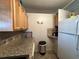 Kitchen corner with granite countertop and built-in appliances at 707 Riverview Cir, North Port, FL 34287