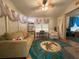 Sunroom with couches, a work desk and a palm tree rug at 707 Riverview Cir, North Port, FL 34287