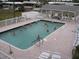 Community swimming pool with plenty of lounge chairs at 707 Riverview Cir, North Port, FL 34287