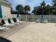 Pool deck with lounge chairs and umbrellas at 8647 Lake Front Ct, Punta Gorda, FL 33950