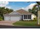 New construction home with a two-car garage and attractive landscaping at 25236 Rampart Blvd, Punta Gorda, FL 33983