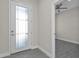 Bright foyer with white door and gray flooring, view into another room at 4255 Oak Terrace Cir, Port Charlotte, FL 33953