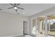 Bright bedroom with grey flooring and sliding glass doors leading to a screened patio at 4255 Oak Terrace Cir, Port Charlotte, FL 33953