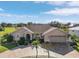 Tan house with a two car garage and nicely landscaped yard at 7417 S Blue Sage, Punta Gorda, FL 33955