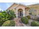 Front entry with stone walkway, landscaping, and double doors at 7417 S Blue Sage, Punta Gorda, FL 33955