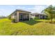 Home with covered patio and fenced backyard at 1384 Raspberry Dr, North Port, FL 34289