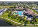 Luxury community amenity center with pool, expansive lawn, and palm trees at 20149 Lagente Cir, Venice, FL 34293