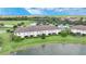 Aerial view of townhomes near a lake with lush green landscaping at 20149 Lagente Cir, Venice, FL 34293