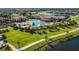 Community pool with surrounding lush landscaping and walking paths at 20149 Lagente Cir, Venice, FL 34293