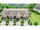 Three attached townhomes viewed from above showcasing rooflines and landscaping at 20149 Lagente Cir, Venice, FL 34293