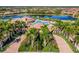 Resort-style community pool, tennis courts, and clubhouse with palm trees and landscaping at 20149 Lagente Cir, Venice, FL 34293