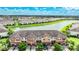 Aerial view of townhomes near a lake with lush green landscaping at 20149 Lagente Cir, Venice, FL 34293