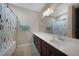Clean bathroom with a double vanity, shower/tub combo and tile flooring at 20149 Lagente Cir, Venice, FL 34293